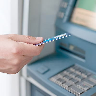 Person using debit card at ATM